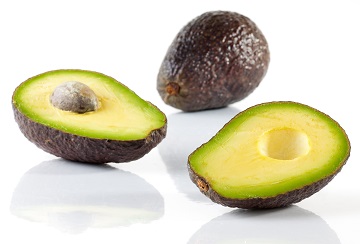 Image of Avocados on white. Shallow depth of field with the first half of avocado in focus with the rest tapering off.