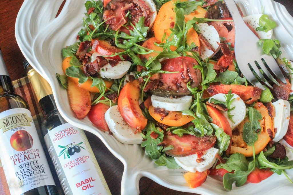 Heirloom Tomato Salad with Nectarines, Fresh Mozzarella, Crumbled Bacon and Arugula, Tossed in a Summertime Peach and Basil Vinaigrette