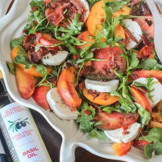 Heirloom Tomato Salad with Nectarines, Fresh Mozzarella, Crumbled Bacon and Arugula, Tossed in a Summertime Peach and Basil Vinaigrette