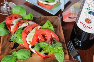 Traditional Caprese with heirloom tomatoes, olive oil and aged balsamic
