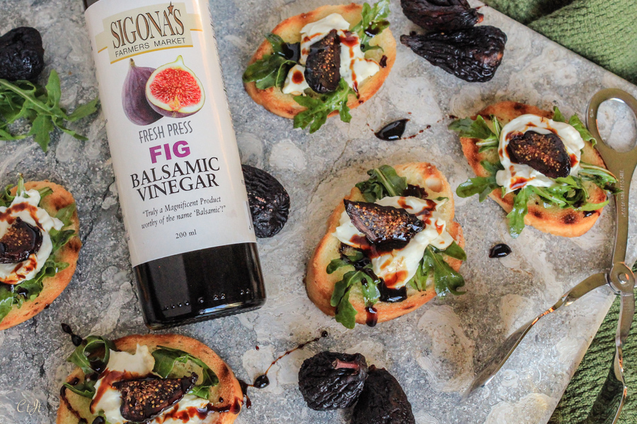 Chèvre & Arugula on Tuscan Herb Toasts with a Fig Balsamic Reduction