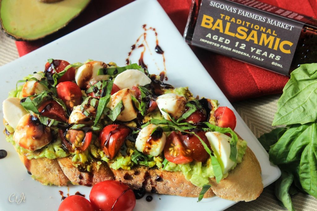 Avocado Toast a la Caprese with a Balsamic Reduction featuring Sigona's Traditional 12-year-aged Balsamic Vinegar and Sigona's Garlic Oil.