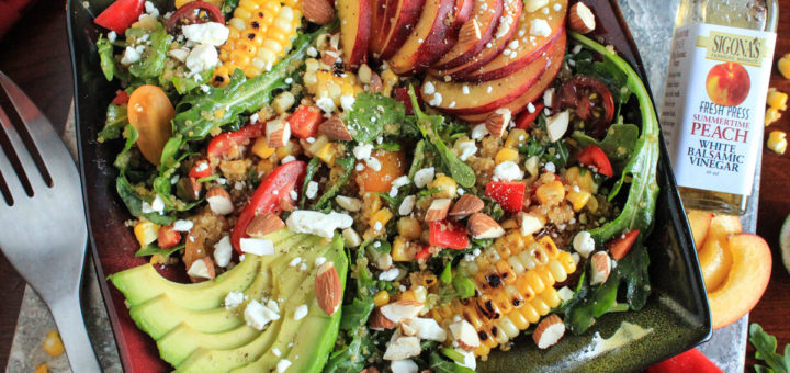 Fresh Peach Grilled Corn and Arugula Quinoa Bowl with a Peach and Baklouti Green Chili Vinaigrette featuring Sigona's Summertime Peach White Balsamic and Sigona's Spicy Baklouti Olive Oil a fantastic loaded salad buddah bowl