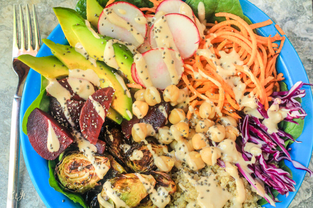 Buddha Bowl with Sweet Potatoes, Beets, Quinoa, Brussels Sprouts and More, Topped with a Tahini Dressing