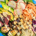 Buddha Bowl with Sweet Potatoes, Beets, Quinoa, Brussels Sprouts and More, Topped with a Tahini Dressing